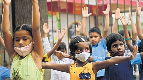 Children exercise at the Higher Primary School in Devarachikkanahalli near Bannerghatta Road in Bengaluru as schools reopen after two years on Monday | Ashishkrishna HP