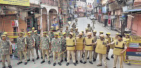 Policemen stand guard during the third and last day of the controversial videographic survey at the Gyanvapi mosque complex, in Varanasi on Monday | PTI
