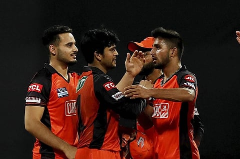 Umran Malik of Sunrisers Hyderabad celebrates with teammates, the wicket of Daniel Sams of Mumbai Indians during the 65th T20 cricket match of the Indian Premier League 2022. (Photo | PTI)