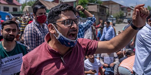 Kashmiri Pandits shout slogans during a protest against the killing of Rahul Bhat on the outskirts of Srinagar. (Photo | AP)