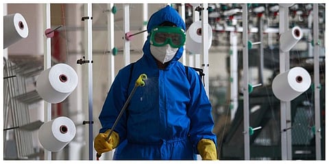 An employee of Songyo Knitwear Factory in Songyo district disinfects the work floor in Pyongyang, North Korea, Wednesday, May 18, 2022. (Photo |AP)