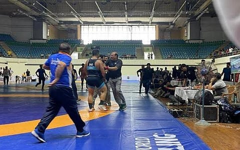 Wrestler Satendra Malik (2nd from left) involved in a heated arguments with the referee during selection trials at the IG Stadium in New Delhi on Tuesday. (Photo | Twitter)