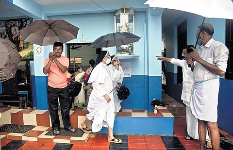 Nuns  returning after casting their votes amid torrential rain in the 62nd division byelection of Kochi corporation on Tuesday  | A Sanesh