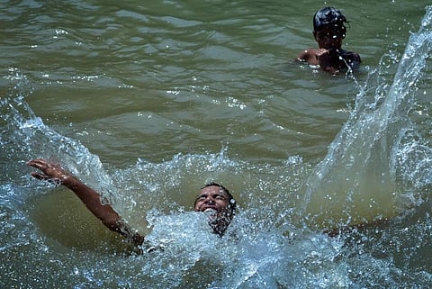 Boys take a dip in a canal to beat the heat on the outskirts of Amritsar. (File Photo | PTI)