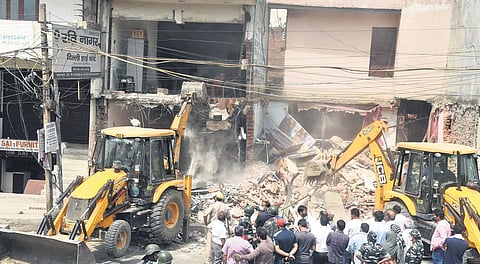Bulldozers demolish structures during an anti-encroachment drive at Khichripur village on Wednesday | parveen negi