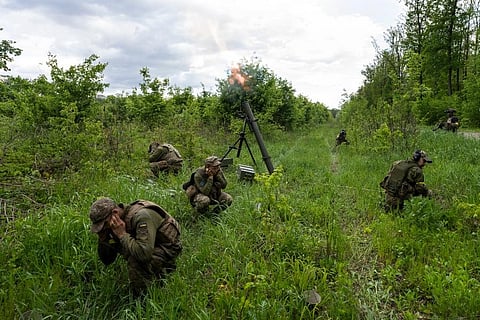 Ukrainian servicemen accompanied by members of the foreign legion fire mortars at Russian positions in the eastern regions of Ukraine. (Photo | AP)