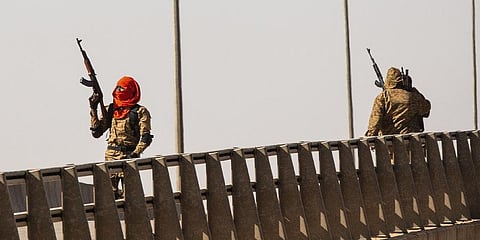 A mutinous soldier fires into the air at the Bobo interchange, near the Lamizana camp in Burkina Faso's capital Ouagadougou Sunday Jan. 23, 2022.(File Photo | AP)