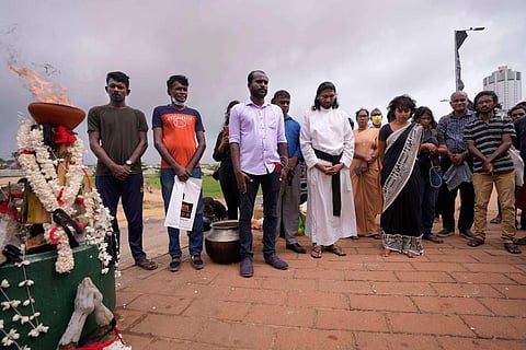 Human rights activists observe a minute silence in remembrance of victims of Sri Lanka's civil war, at the ongoing anti government protest site in Colombo, Sri Lanka. (Photo | AP)