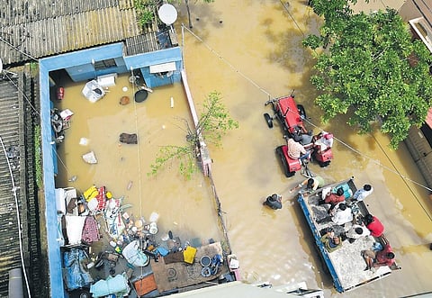 BBMP workers carry food packets on a tractor on Wednesday to distribute to residents of Vaddarapalya near Horamavu after Tuesday’s heavy downpour in Bengaluru. (Photo | Shriram BN)