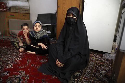 Afghan refugee Zahra Husseini and her children Salehe, center, and Shahrzad sit in their room in a poor suburb of Tehran, Iran, April 21, 2022. (Photo | AP)