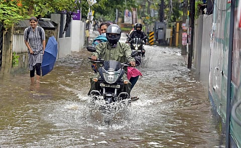 Motorists wading through a flooded road near Edappally Ganapathi temple in Kochi.(Photo | A Sanesh, EPS)