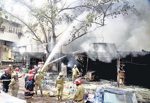 Firefighters try to douse a blaze that broke out in Jhandewalans cycle market  on Friday | parveen negi