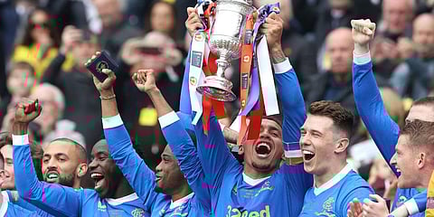 Rangers' James Tavernier lifts the Scottish Cup after the final whistle of the Scottish Cup soccer final between Heart of Midlothian FC and Rangers at Hampden Park, Glasgow, Scotland. (Photo | AP)