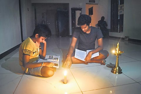 Children studying in candlelight in a house in Karanai Puducherry near Urapakkam where 150 families are yet to get power connections | Ashwin Prasath