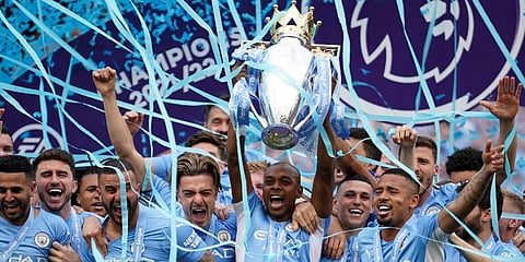 Manchester City players celebrate with trophy after winning the 2022 English Premier League title at the Etihad Stadium in Manchester, England. (Photo | AP)