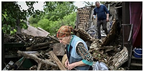 An eldery woman stands outside her heavily damaged house after it was hit by a missile in the city of Bakhmut in the eastern Ukranian region of Donbass on May 22, 2022. (Photo |AFP)