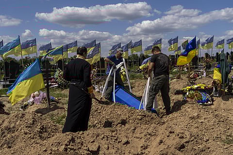 Undertakers lower the coffin of Ukrainian serviceman Oleksander Matyukhin, 32, in Kharkiv, eastern Ukraine, Monday, May 23, 2022. (Photo | AP)