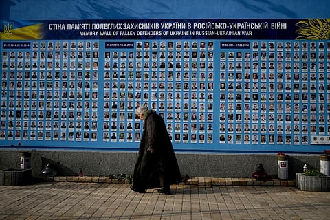 A woman walks past the Memorial Wall of Fallen Defenders of Ukraine in Russian-Ukrainian War in Kyiv, Ukraine. (Photo | AP)