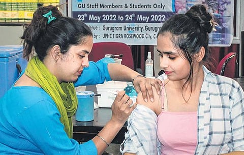 A healthcare worker administers a Covid-19 dose to a beneficiary (Photo | PTI)