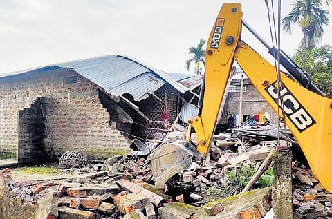 An earthmover during an eviction drive carried out by district administration after incidents of violence in Nagaon district, Assam | PTI