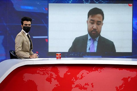 TV anchor Hamed Bahram wears a face mask to protest the Taliban's new order that female presenters cover their faces, as he reads the news on TOLOnews, in Kabul. (Photo | AP)