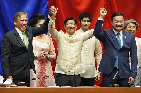 President-elect Ferdinand 'Bongbong' Marcos Jr., center, raises hands with Senate President Vicente Sotto III, left, and House Speaker Lord Allan Velasco. (Photo | AP)