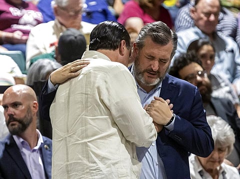 U.S. Sen. Ted Cruz prays with a community member during a vigil held in honor of the lives lost at Robb Elementary the day before at the Uvalde County Fairplex Arena in Uvalde. (Photo | AP)