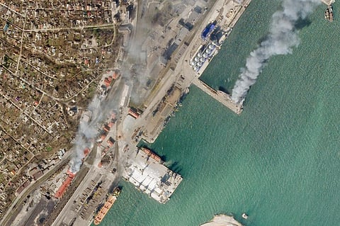 In this satellite photo from Planet Labs PBC, a Ukrainian naval vessel and a nearby building burn in the besieged city of Mariupol, Ukraine. (File Photo | AP)