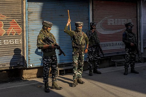 Paramilitary soldiers stand guard after chasing people who were protesting against sentencing of Kashmiri separatist leader Yasin Malik, in Srinagar. (Photo | AP)