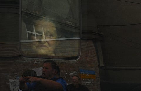 A Ukrainian woman peers through a bus window as civilians evacuate Soledar in the Donetsk region of Ukraine, Tuesday, May 24, 2022. (Photo | AP)