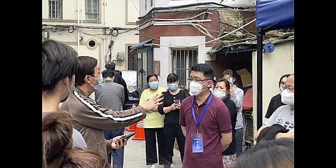 Residents confront a representative about opening up of their compound in Jingan district in Shanghai on May 25, 2022.(Photo | AP)