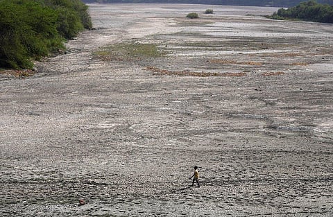 A man walks across an almost dried up bed of river Yamuna following hot weather in New Delhi, India, Monday, May 2, 2022. (Photo | AP)