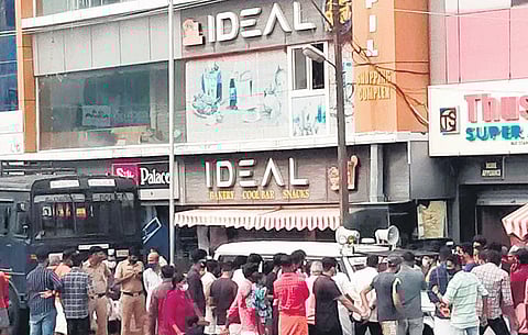 People gathered in front of Ideal snacks bar soon after hearing about the death of 16-year-old Devananda on May 1, 2022.