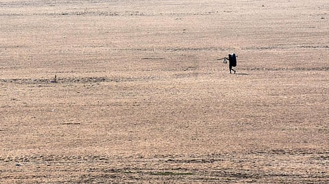 A fisherman on his way for work under the scorching summer heat in Vijayawada on Monday. (Photo | P Ravindra Babu, EPS)