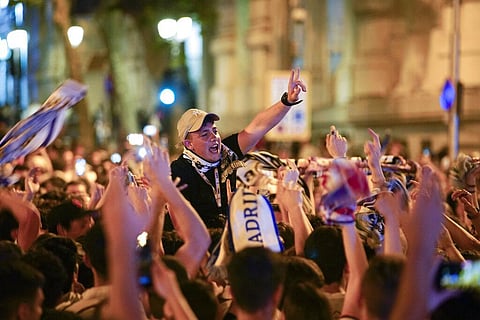 Real Madrid supporters celebrate at the end of the Champions League soccer final in Cibeles square in downtown Madrid, Spain, Sunday, May 29, 2022. (Photo | AP)