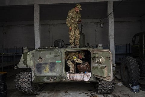 Ukrainian servicemen inspect a Russian MT-LB in the Kharkiv area, eastern Ukraine, Sunday, May 29, 2022. (Photo | AP)