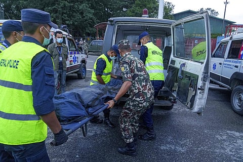 Nepalese army officials shift the dead body of a plane crash victim to an ambulance at an airport in Kathmandu, Nepal, Monday, May 30, 2022. (Photo | AP)