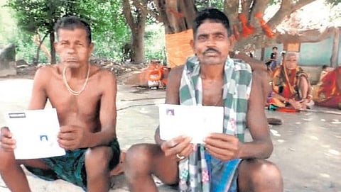Villagers showing their bank passbooks at Dhinkia. (Photo | EPS)
