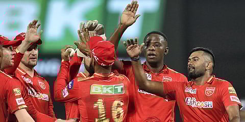 Kagiso Rabada of Punjab Kings celebrates with teammates, after taking the wicket of Wriddhiman Saha of Gujarat Titans during the IPL match at the DY Patil Stadium in Mumbai. (Photo | PTI)