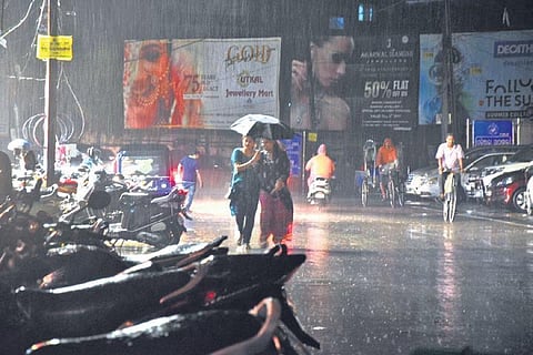People caught in the rains that lashed Cuttack on Tuesday evening. (Photo | EPS)