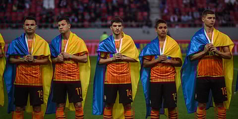Players of Shakhtar Donetsk hold Ukrainian flags on their shoulders before a friendly charity football match at the Karaiskaki Stadium in Athens. (File photo| AFP)