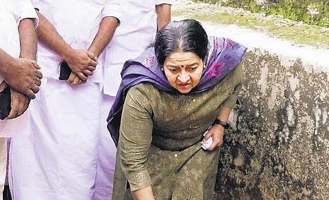 Uma Thomas, the UDF candidate in the Thrikkakara bypoll, kneels down to touch the tomb of her husband P T Thomas at St Joseph’s Church cemetery | Express