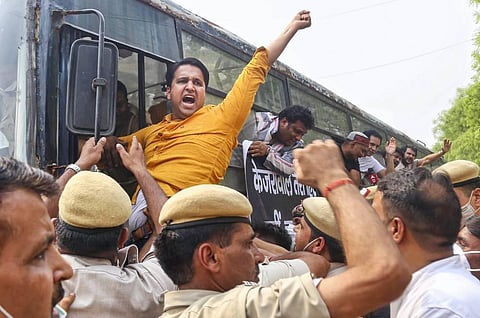 Bharatiya Janata Yuva Morcha activists shout slogans as they are detained by the police during a protest over the arrest of BJP leader Tajinder Pal Singh Bagga by the Punjab Police. (Photo | PTI)
