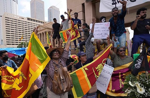 Sri Lankans shout slogans at the ongoing protest site against the economic crisis outside the president's office in Colombo, Sri Lanka. (Photo | AP)