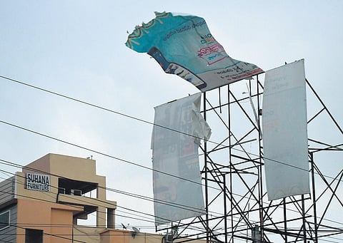 A billboard damaged by gusty wind in Vijayawada on Friday. (Photo | Prasant Madugula, EPS)