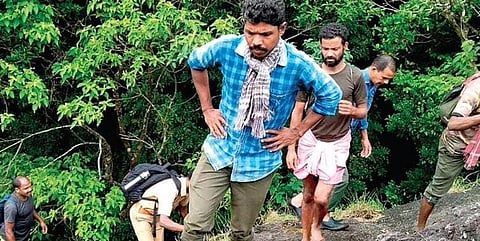 Forest personnel and tribal watchers combing the Silent Valley forests in Palakkad for the missing watcher on Friday | Express  