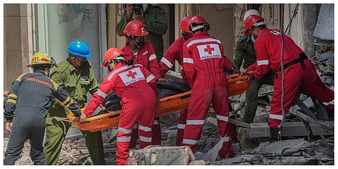 Rescuers recover a body at the site of Friday's deadly explosion that destroyed the five-star Hotel Saratoga, in Havana, Cuba, Saturday, May 7, 2022.  (Photo | AP)