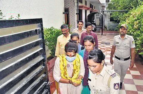 Prime accused in the PSI CET scam Divya Hagaragi being taken by CID sleuths to her residence and Jnana Jyoti English Medium School for a spot visit. (Photo| EPS)