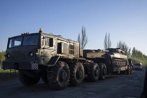 A military truck transports a platform with Ukrainian self-propelled artillery mount in Donetsk region, Ukraine, Sunday, May 8, 2022. (Photo  | AP)