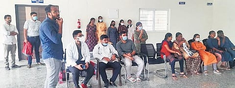 Students of MNR Medical College wait outside the office of KNRUHS Vice-Chancellor Dr B Karunakar Reddy in Warangal. (Photo| EPS)